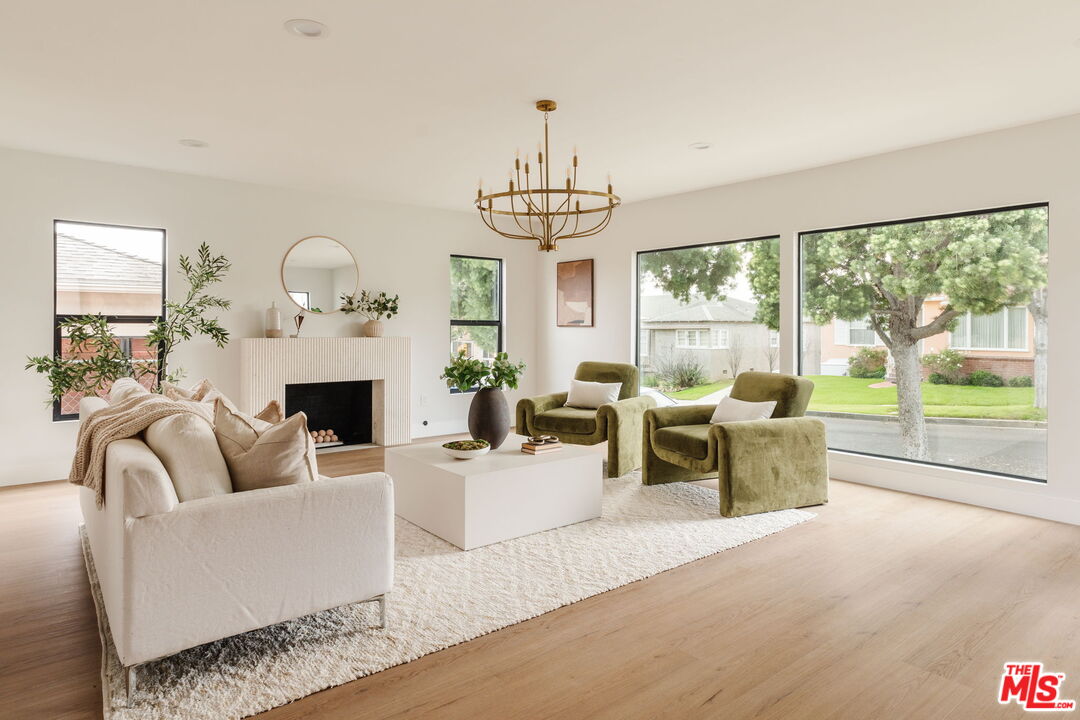 5168 Southridge Avenue Los Angeles, CA 90043 - Photo 16 of 74 a living room with furniture a fireplace and a large window