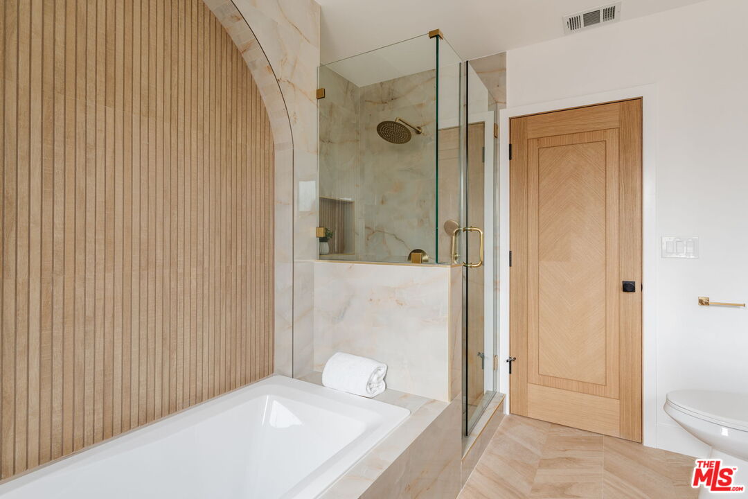 5168 Southridge Avenue Los Angeles, CA 90043 - Photo 38 of 74 a bathroom with a shower and a toilet