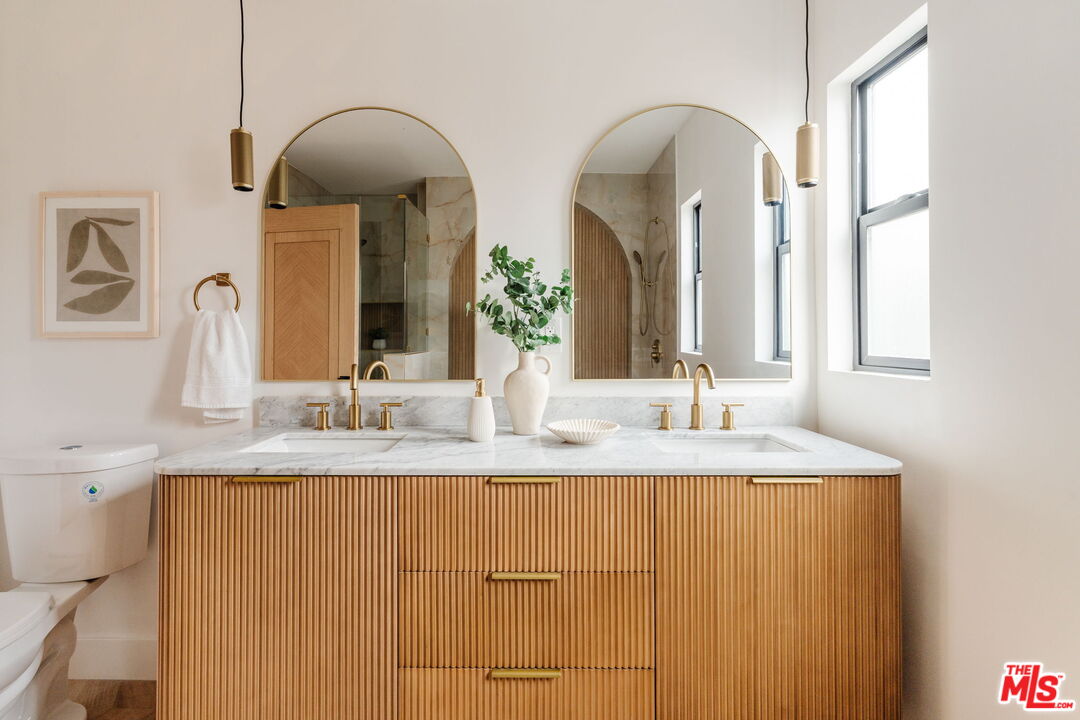 5168 Southridge Avenue Los Angeles, CA 90043 - Photo 40 of 74 a bathroom with double vanity sinks and a mirror