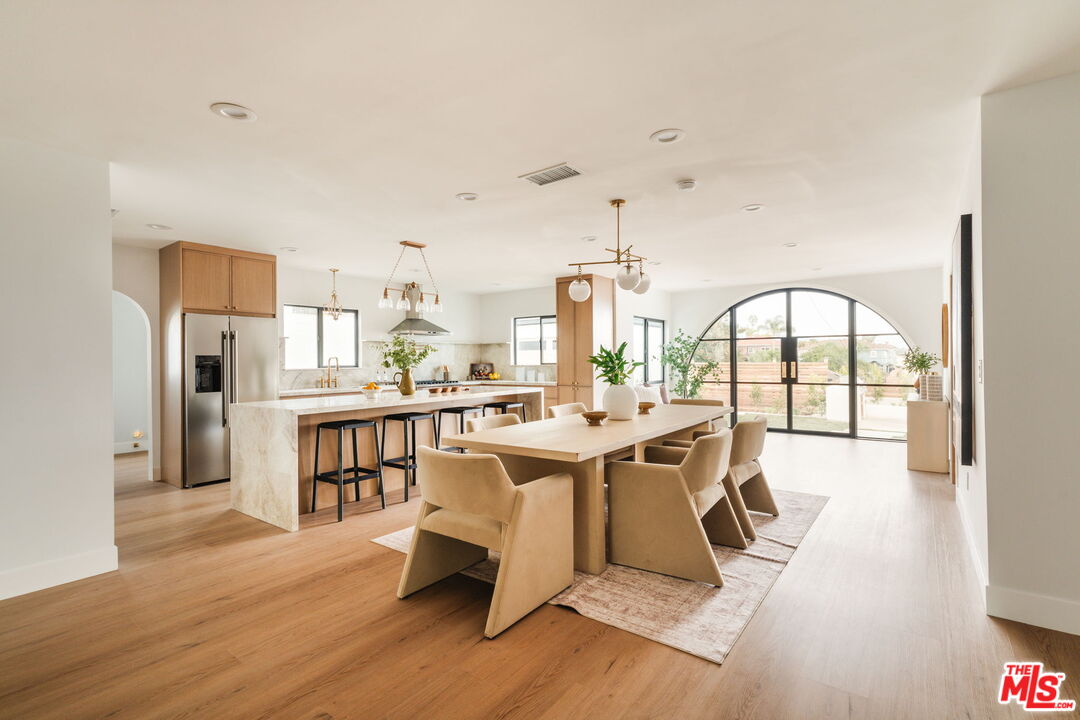 5168 Southridge Avenue Los Angeles, CA 90043 - Photo 6 of 74 a view of a dining room with furniture a chandelier and wooden floor