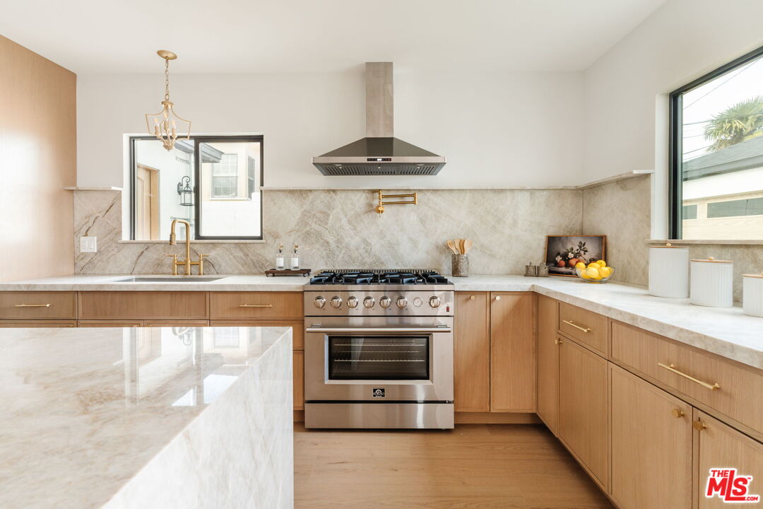 5168 Southridge Avenue Los Angeles, CA 90043 - Photo 8 of 74 a kitchen with stainless steel appliances granite countertop a stove and a sink