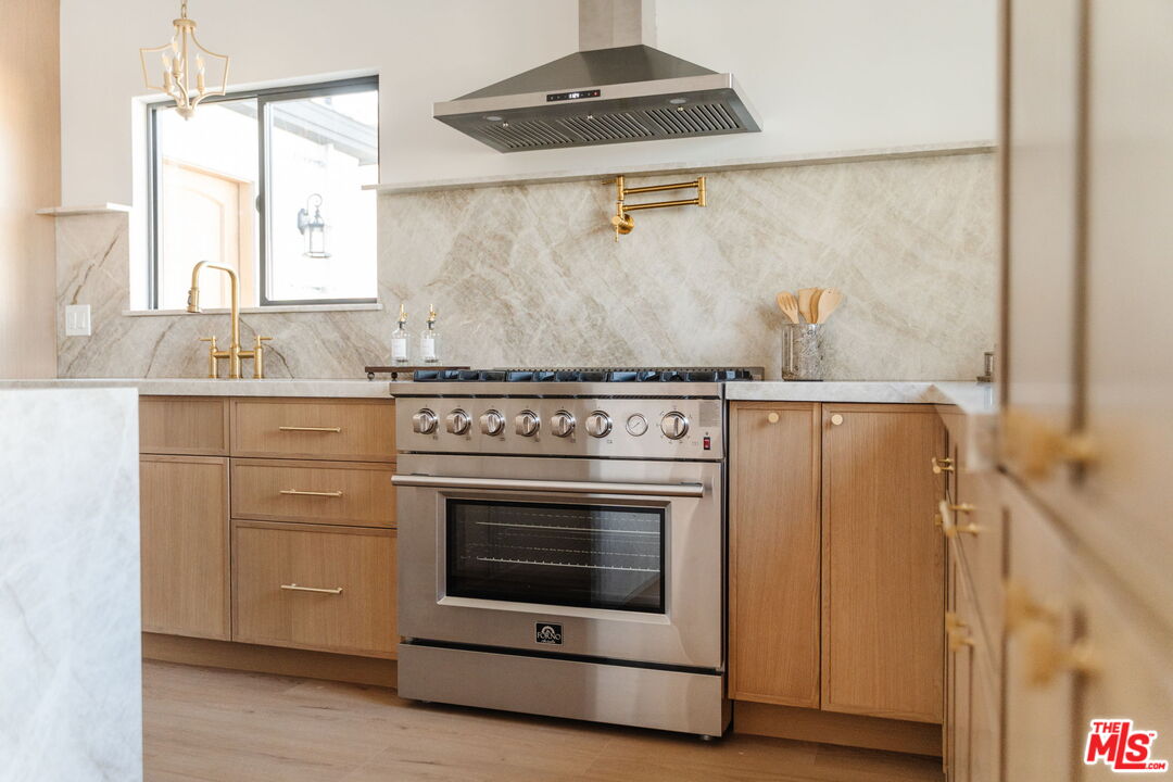 5168 Southridge Avenue Los Angeles, CA 90043 - Photo 9 of 74 a stove top oven sitting inside of a kitchen