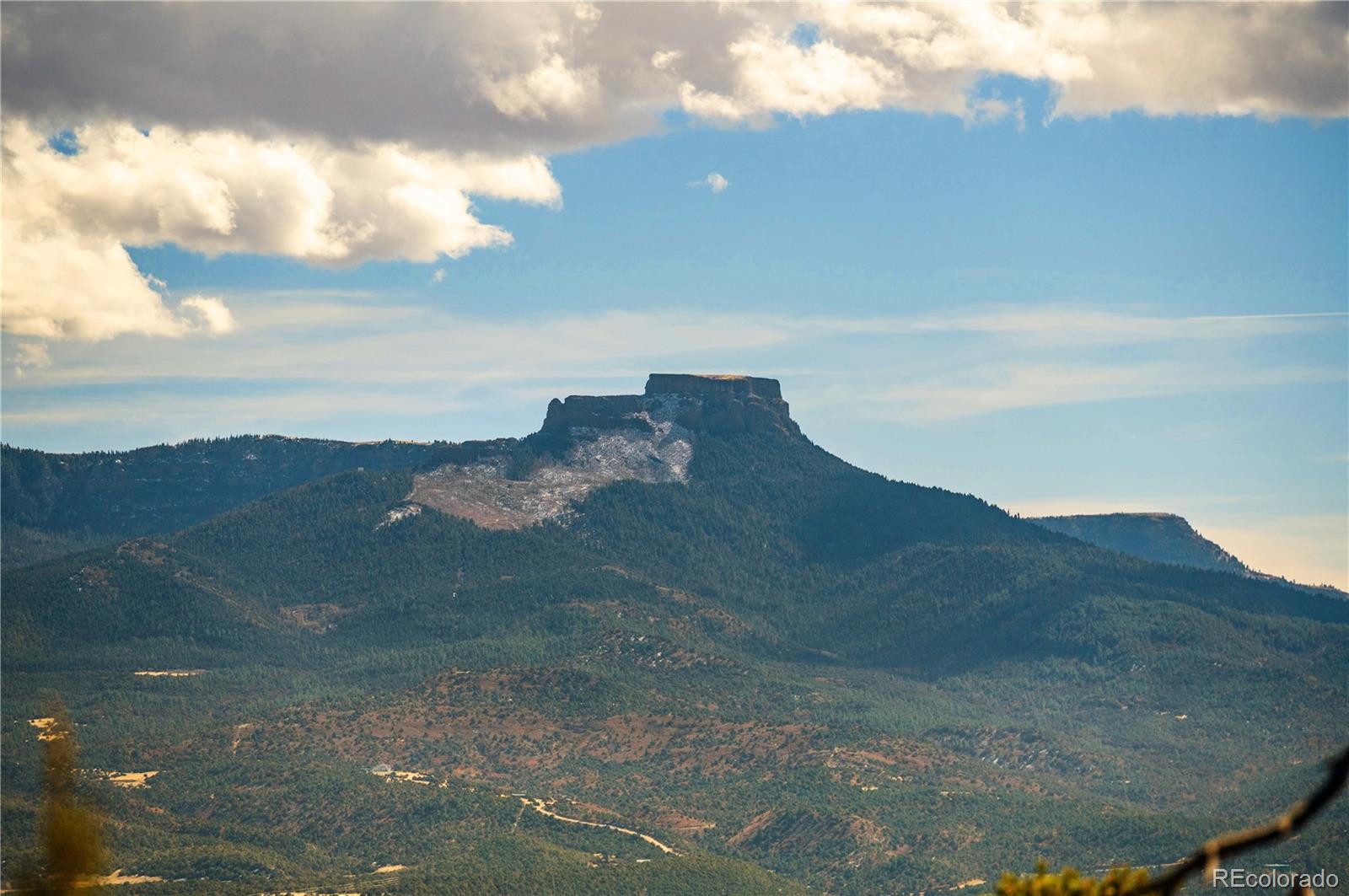 26 Rancho Verde Road Trinidad, CO 81082 - Photo 8 of 37 a view of a dry yard with mountains in the background