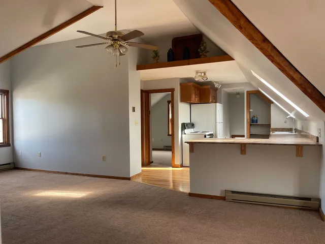 a view of a living room with a ceiling fan