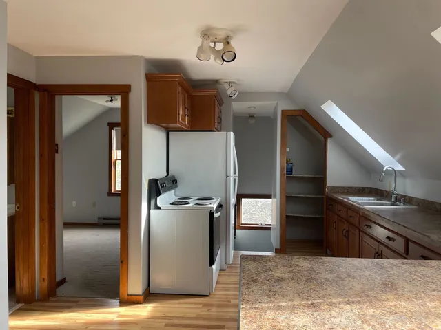 a kitchen with stainless steel appliances kitchen island a refrigerator sink and stove