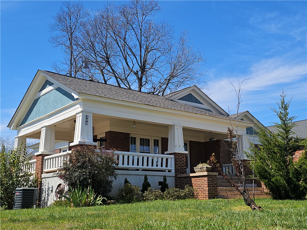 This charming home showcases a welcoming facade with a classic porch and elegant architectural details.