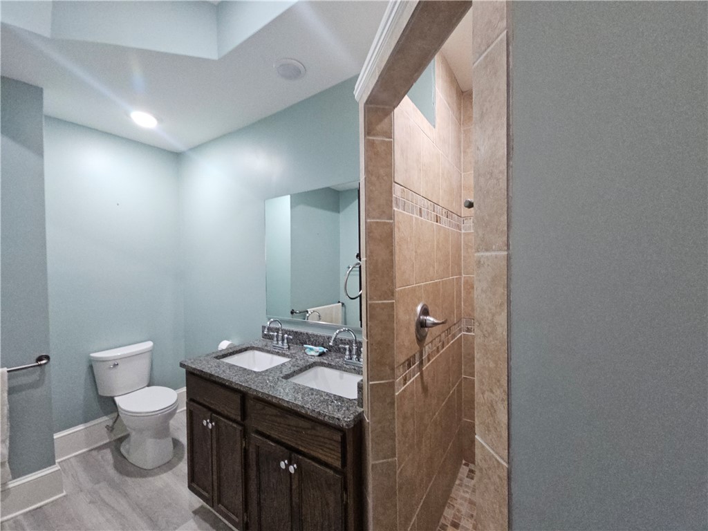 208 Pendleton Street Pickens, SC 29671 - Photo 15 of 30 This bathroom features dual vanities, granite counters, and a tiled shower for comfort and utility.