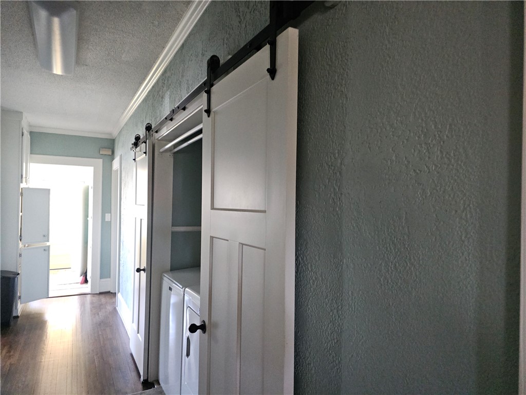 208 Pendleton Street Pickens, SC 29671 - Photo 17 of 30 This functional space features convenient laundry facilities with stylish barn doors and rich flooring.