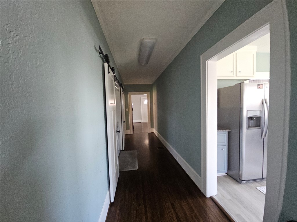 208 Pendleton Street Pickens, SC 29671 - Photo 20 of 30 This spacious hallway features rich flooring, leading to a modern kitchen.