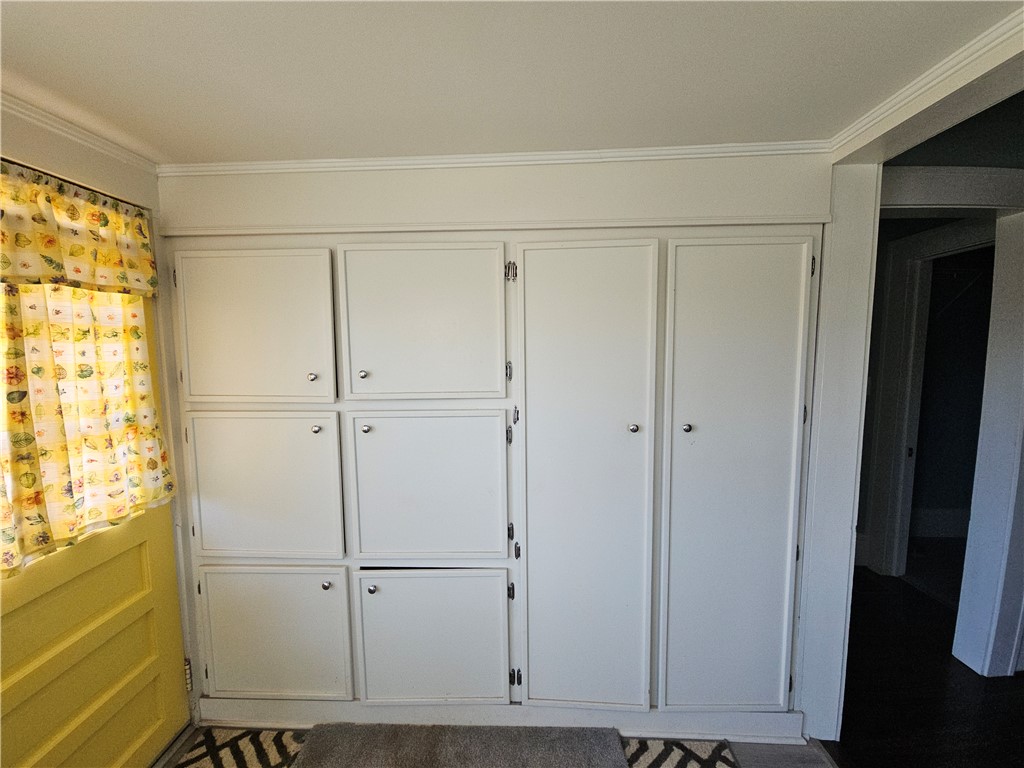 208 Pendleton Street Pickens, SC 29671 - Photo 21 of 30 This interior space features built-in cabinetry, crown molding, and lovely flooring.