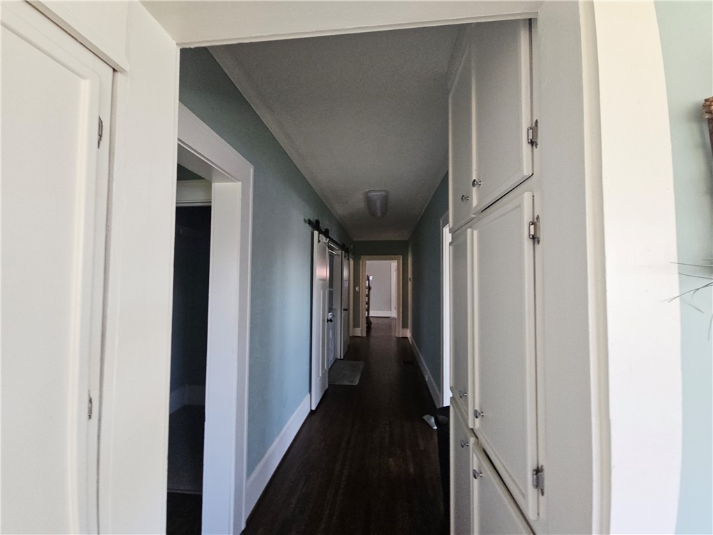 208 Pendleton Street Pickens, SC 29671 - Photo 24 of 30 This spacious hallway features rich hardwood flooring and convenient built-in storage.
