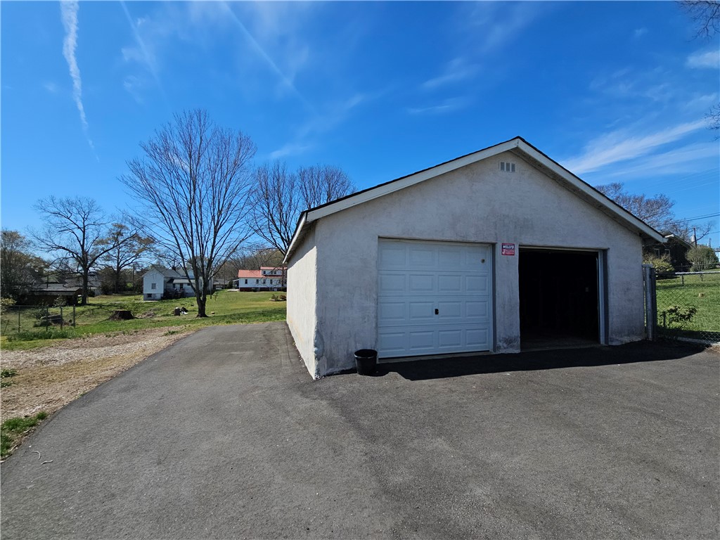 208 Pendleton Street Pickens, SC 29671 - Photo 29 of 30 This functional garage with an asphalt driveway offers practical parking and storage solutions.