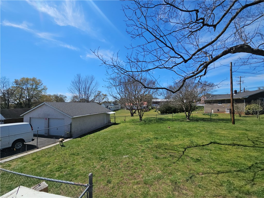 208 Pendleton Street Pickens, SC 29671 - Photo 4 of 30 Expansive green space featuring a detached garage, ideal for hobbies or additional parking.