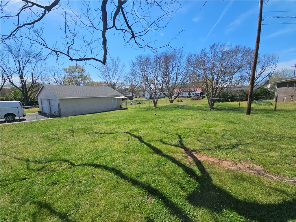 208 Pendleton Street Pickens, SC 29671 - Photo 6 of 30 Expansive green lot featuring a versatile detached garage building and ample outdoor space.