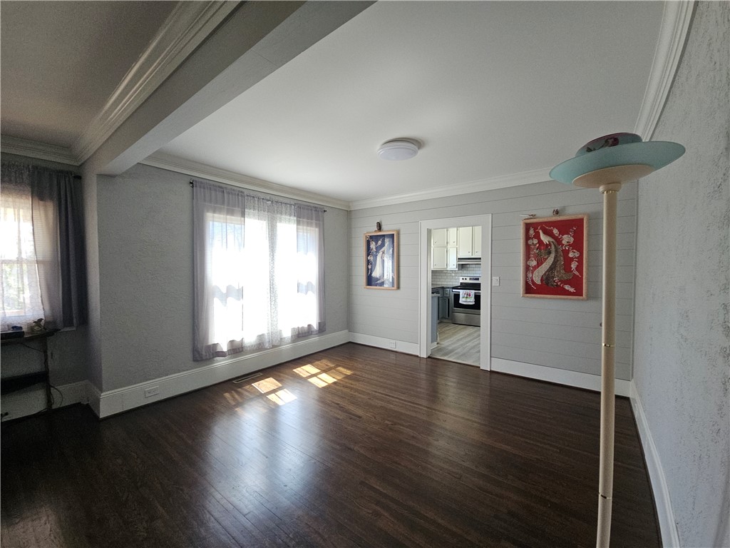 208 Pendleton Street Pickens, SC 29671 - Photo 8 of 30 This inviting living space features rich hardwood flooring, crown molding, and abundant natural light.