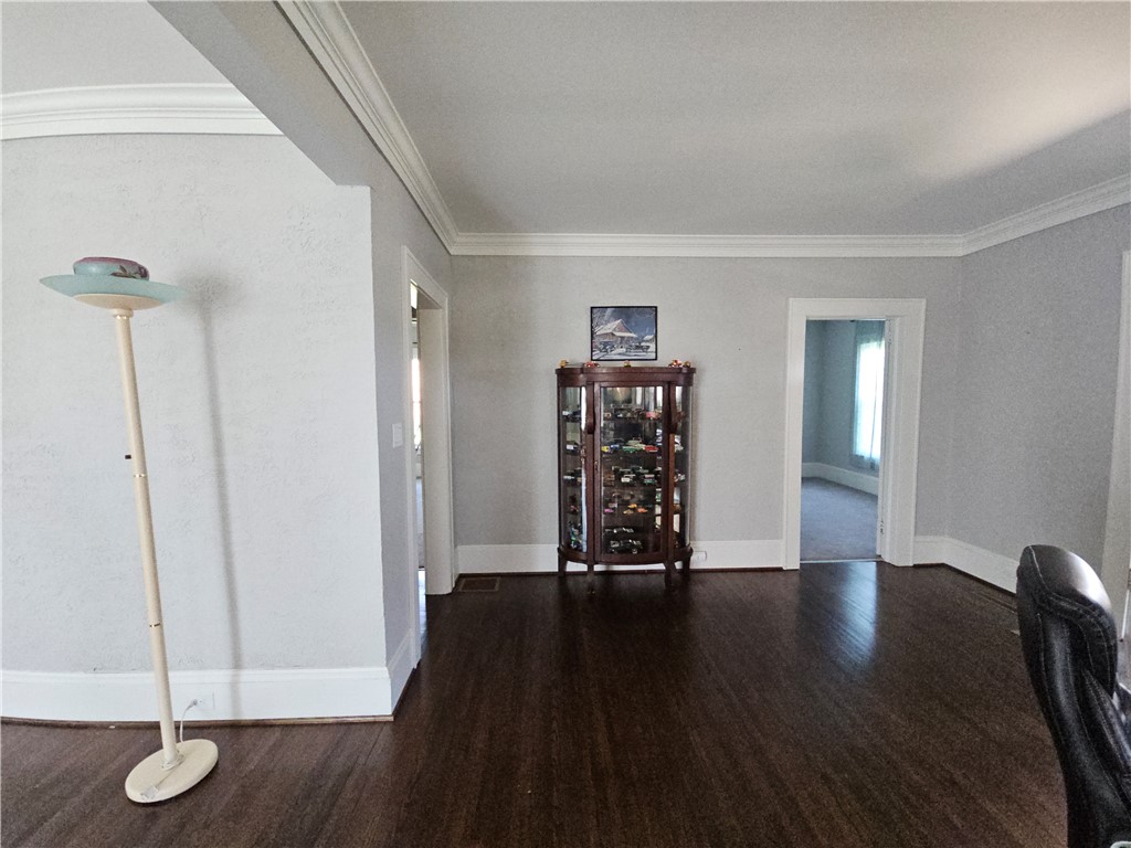 208 Pendleton Street Pickens, SC 29671 - Photo 9 of 30 Elegant hardwood flooring grounds this inviting room, featuring classic crown molding.
