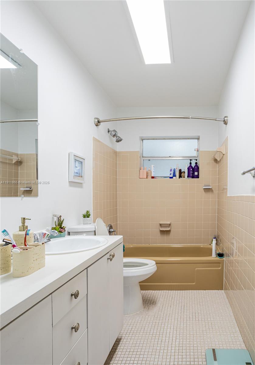 7940 Northwest 9th Street Margate, FL 33063 - Photo 12 of 21 a bathroom with a sink a toilet and a mirror
