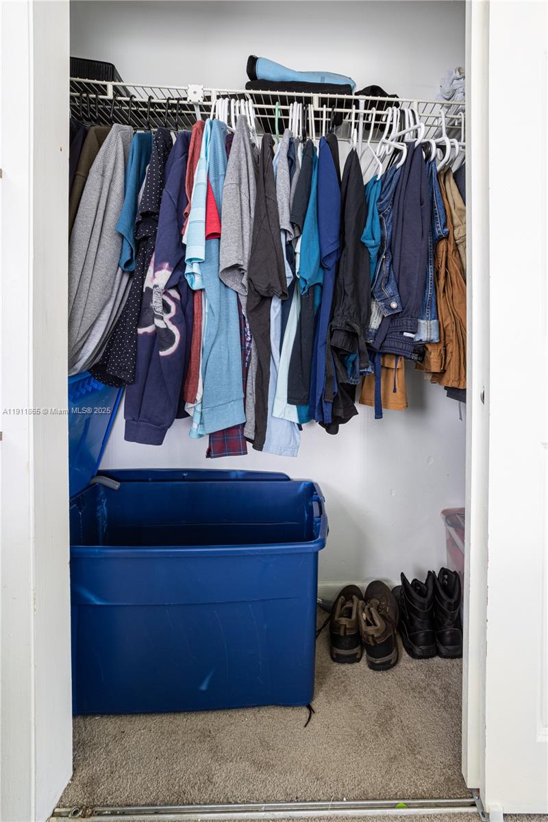 7940 Northwest 9th Street Margate, FL 33063 - Photo 15 of 21 a view of walk in closet with clothes and shoes