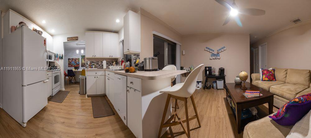 7940 Northwest 9th Street Margate, FL 33063 - Photo 20 of 21 a kitchen that has a lot of cabinets a sink and appliances