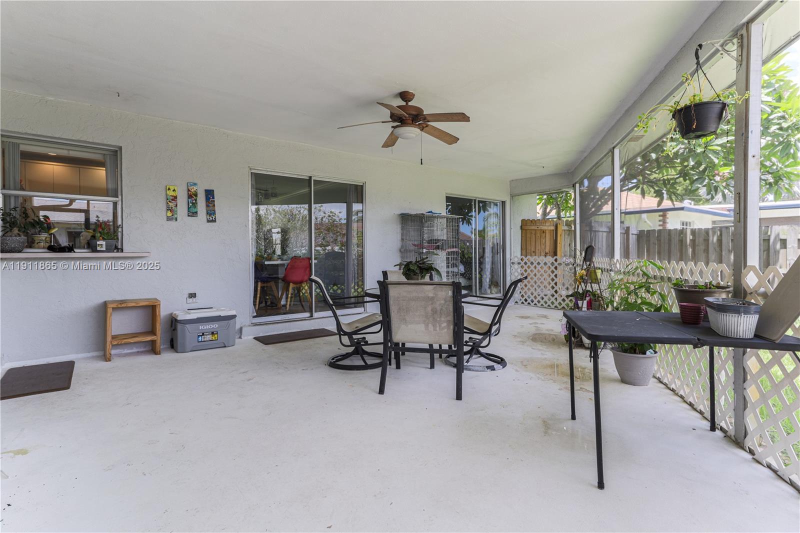 7940 Northwest 9th Street Margate, FL 33063 - Photo 21 of 21 a living room with furniture a fireplace and a floor to ceiling window