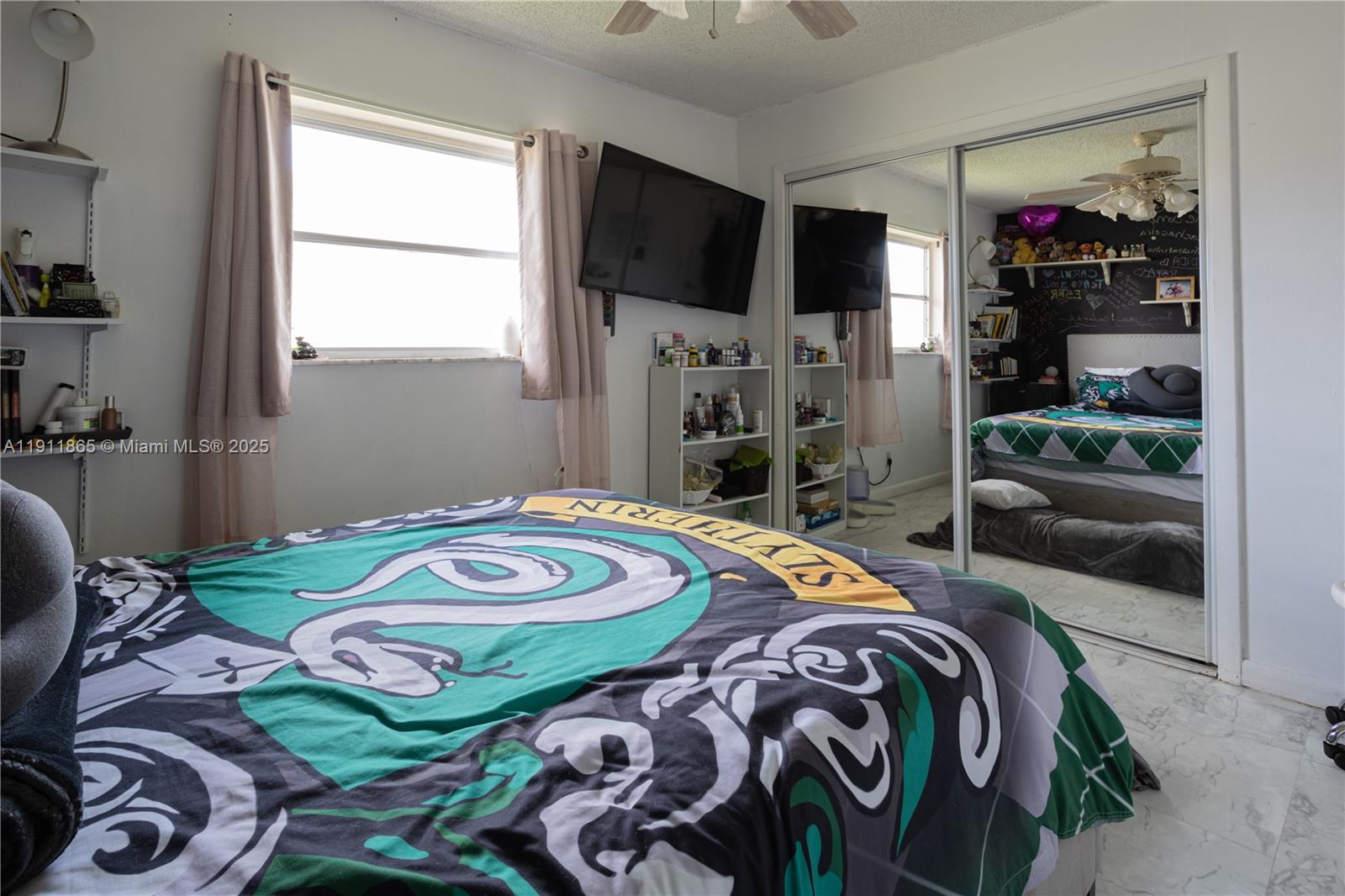 7940 Northwest 9th Street Margate, FL 33063 - Photo 5 of 21 a bedroom with a bed and a tv