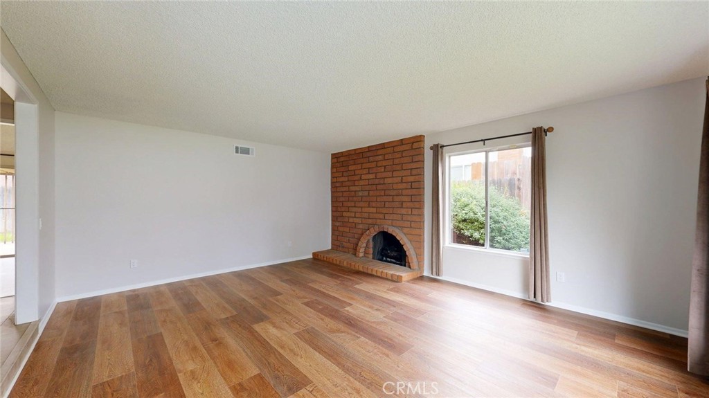 3415 Valencia Hill Drive Riverside, CA 92507 - Photo 11 of 48 a view of empty room with wooden floor and fan