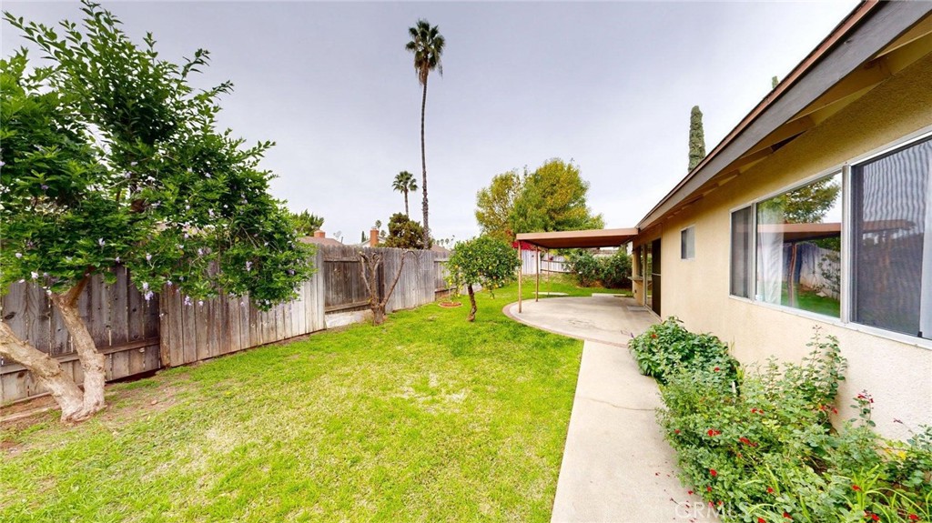 3415 Valencia Hill Drive Riverside, CA 92507 - Photo 38 of 48 a front view of a house with a yard and potted plants