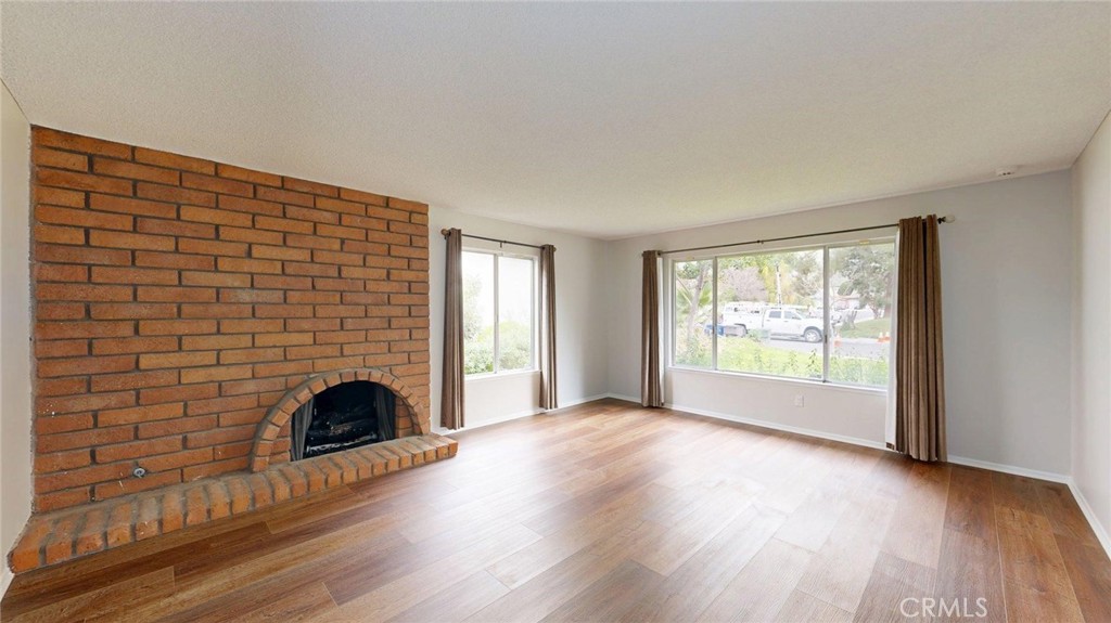 3415 Valencia Hill Drive Riverside, CA 92507 - Photo 10 of 48 a view of an empty room with a fireplace and a window