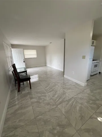 a view of a livingroom with wooden floor and a piano