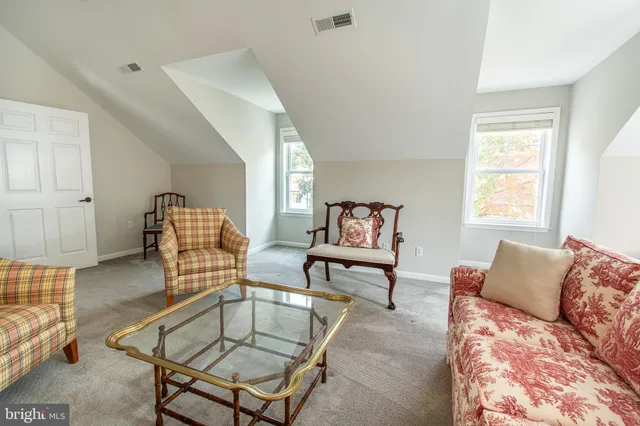 a bedroom with two beds lamp and a chandelier