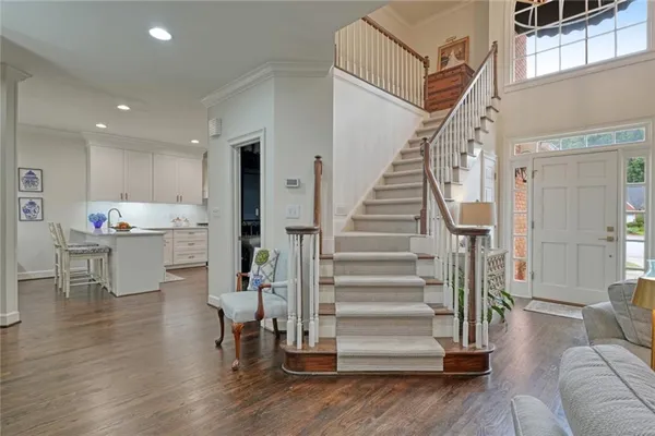 a view of entryway and kitchen with wooden floor