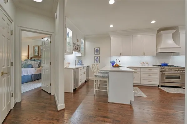 a kitchen with stainless steel appliances a stove and wooden floor