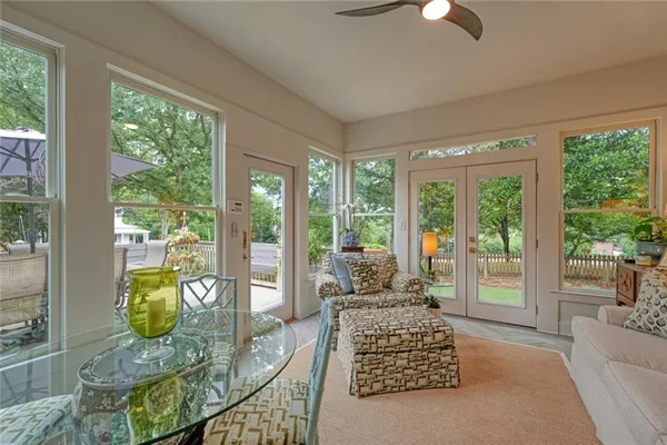 a living room with furniture and floor to ceiling windows