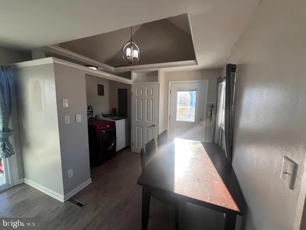 a view of a hallway view with wooden floor and staircase
