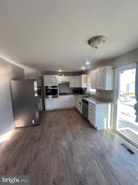 3703 Holly Grove Road Middle River, MD 21220 - Photo 27 of 40 a large kitchen with stainless steel appliances granite countertop a refrigerator a stove a sink and a microwave