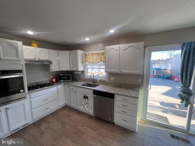 3703 Holly Grove Road Middle River, MD 21220 - Photo 40 of 40 a kitchen with granite countertop white cabinets and white appliances