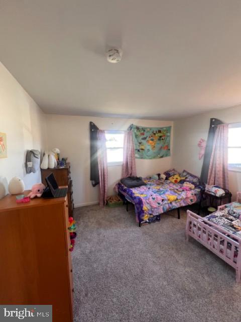 3703 Holly Grove Road Middle River, MD 21220 - Photo 4 of 40 a spacious bedroom with a bed and a chandelier