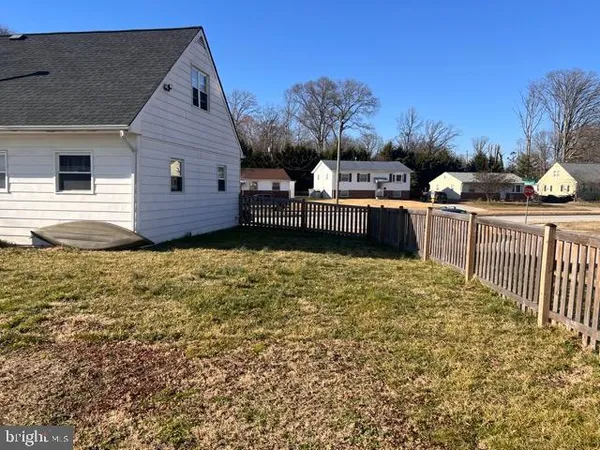 a front view of house with yard and car parked