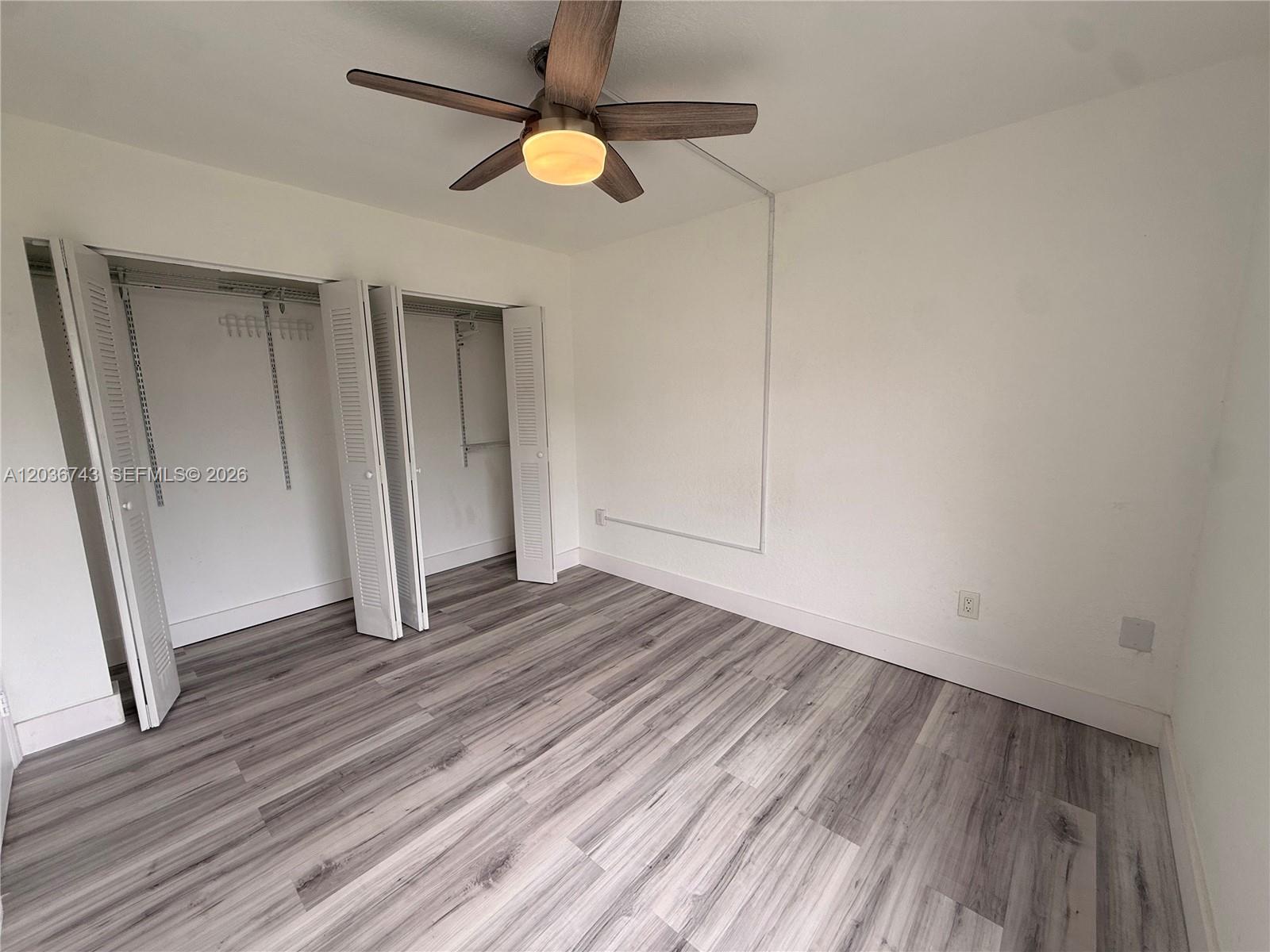 10875 Northwest 7th Street, Unit 1136 Miami, FL 33172 - Photo 15 of 25 wooden floor in an empty room with a window