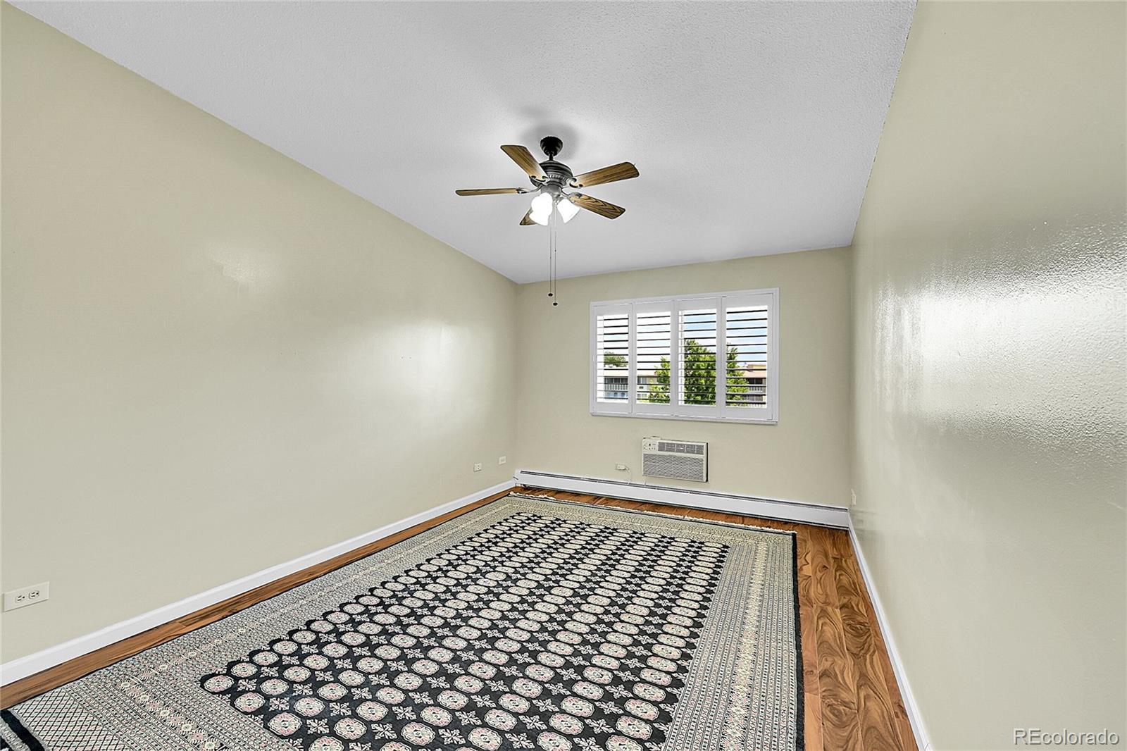 645 South Alton Way, Unit 9D Denver, CO 80247 - Photo 11 of 29 wooden floor in an empty room with a window
