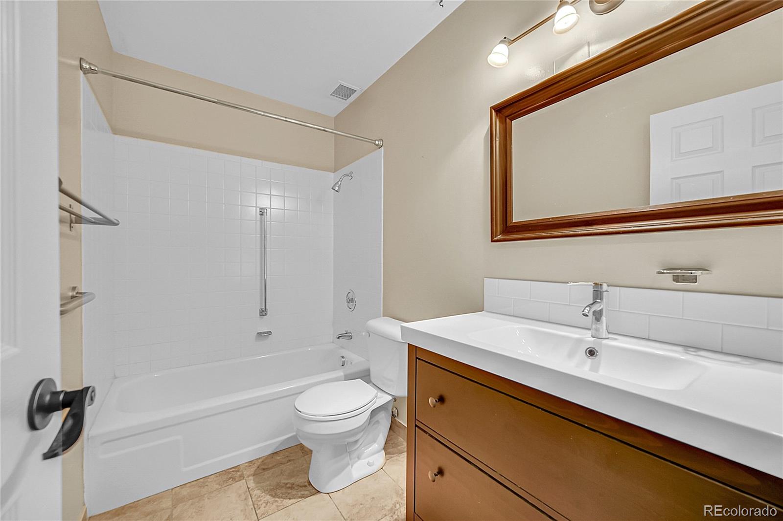 645 South Alton Way, Unit 9D Denver, CO 80247 - Photo 15 of 29 a bathroom with a sink a toilet and shower