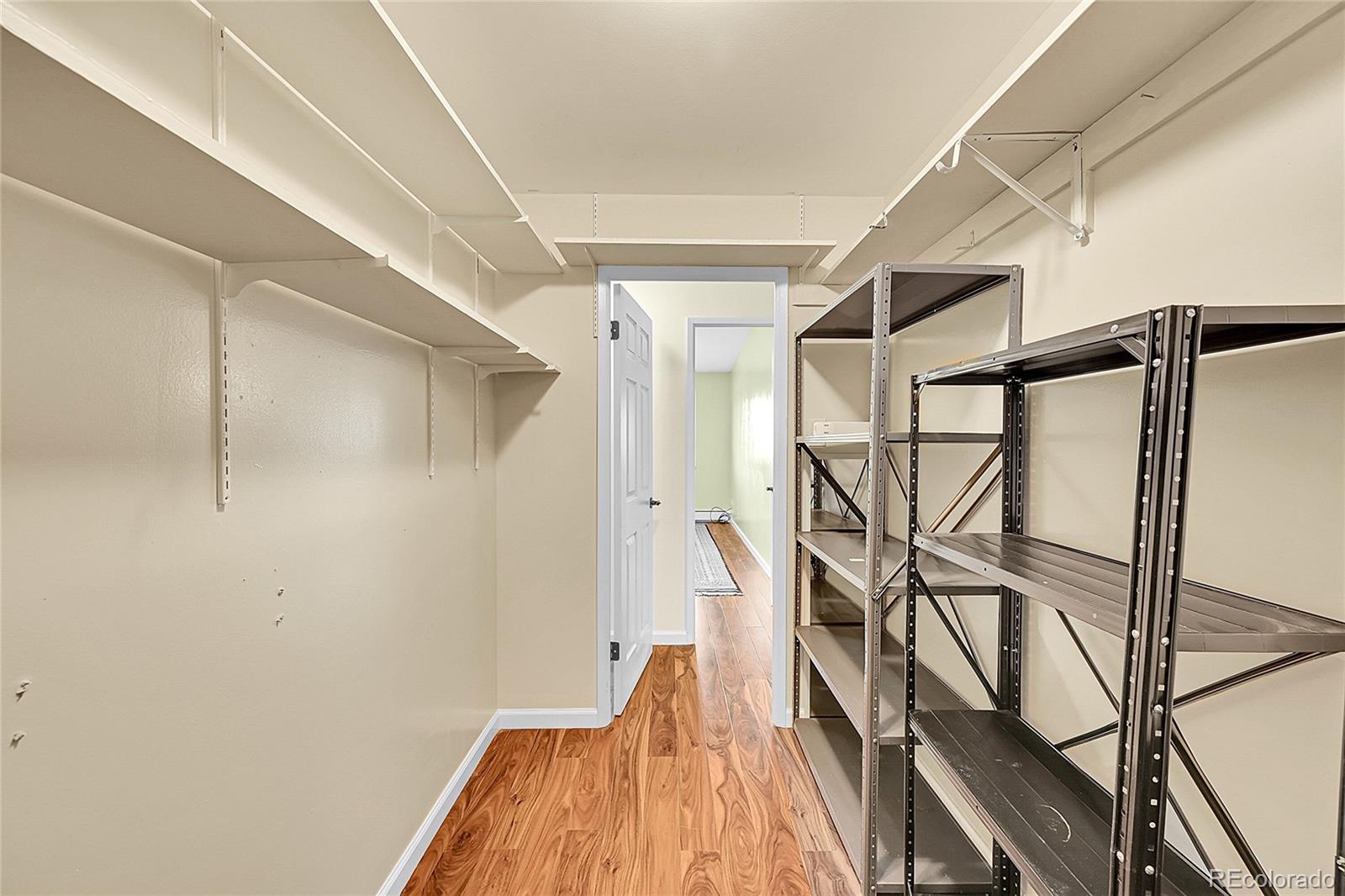 645 South Alton Way, Unit 9D Denver, CO 80247 - Photo 18 of 29 a very nice looking room with wooden floor and a window