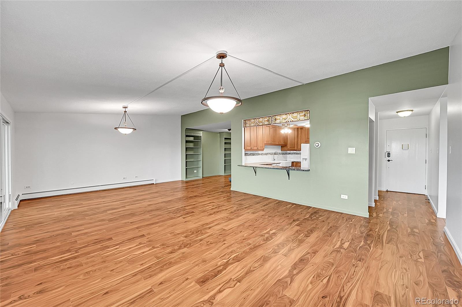 645 South Alton Way, Unit 9D Denver, CO 80247 - Photo 4 of 29 a view of an empty room with wooden floor and a window