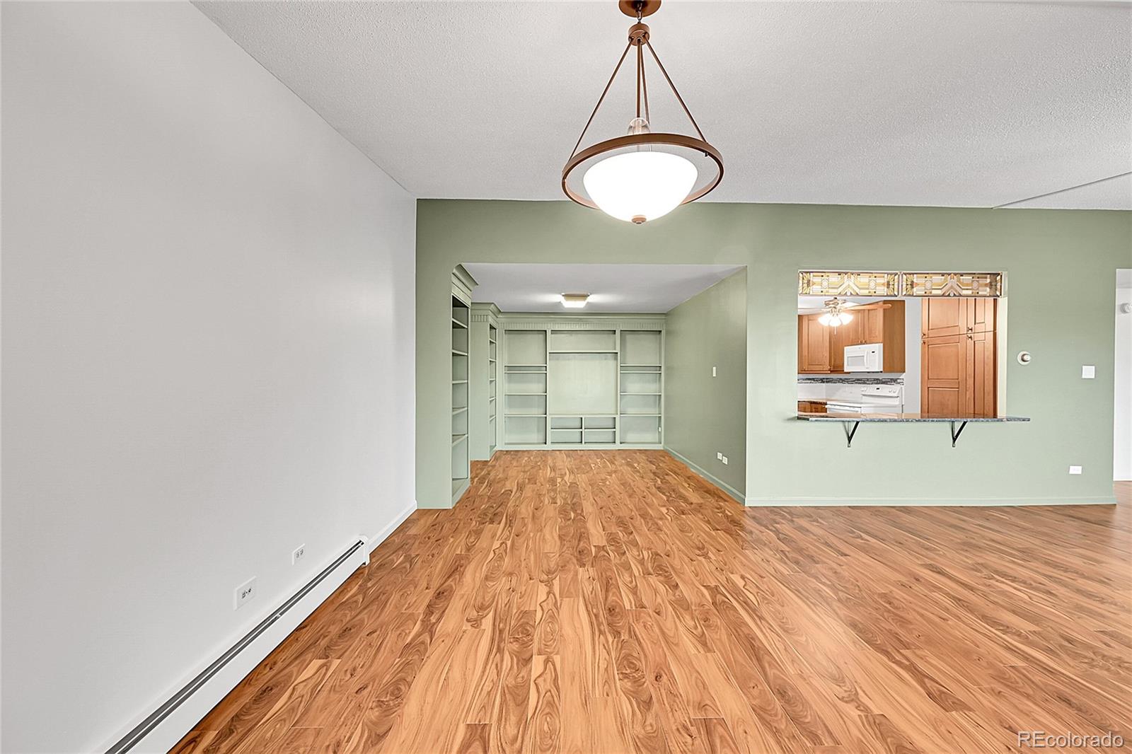 645 South Alton Way, Unit 9D Denver, CO 80247 - Photo 5 of 29 a view of empty room with wooden floor and window