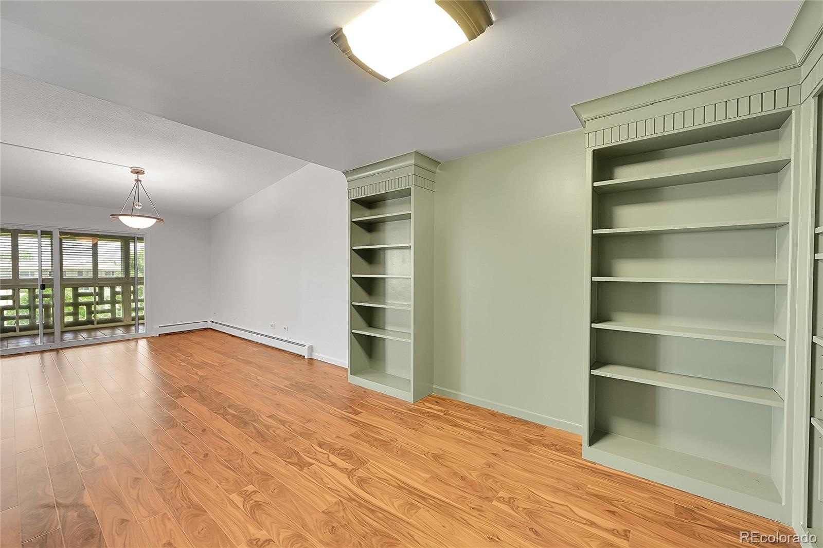 645 South Alton Way, Unit 9D Denver, CO 80247 - Photo 7 of 29 a view of empty room with wooden floor and fan