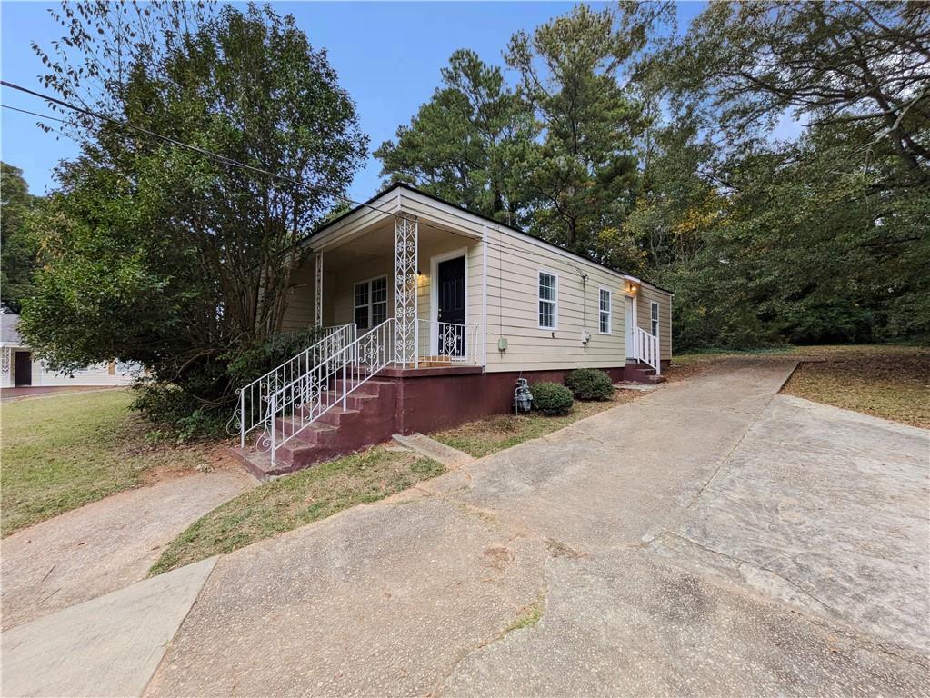 1938 Lomita Road Southeast Atlanta, GA 30316 - Photo 1 of 1 a front view of a house with a yard and trees