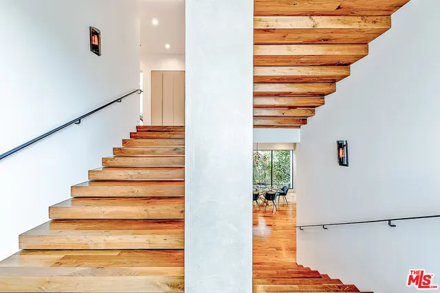 a bedroom with a bed and large window with outer view