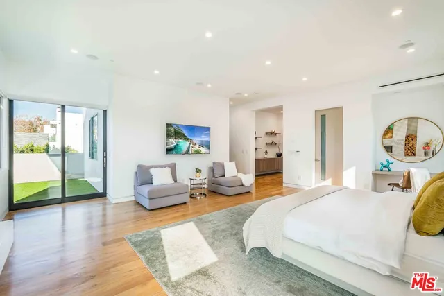 a view of living room with a chandelier and wooden floor