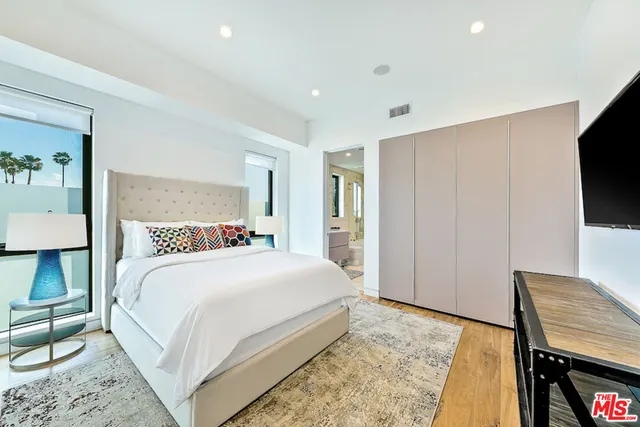 a bathroom with a bathtub shower sink mirror and toilet