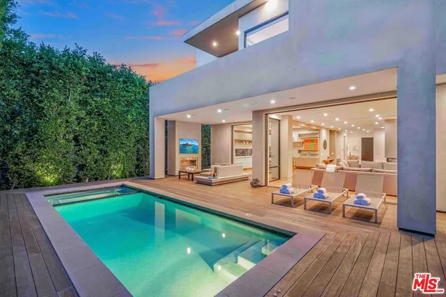a view of a swimming pool with chairs in patio